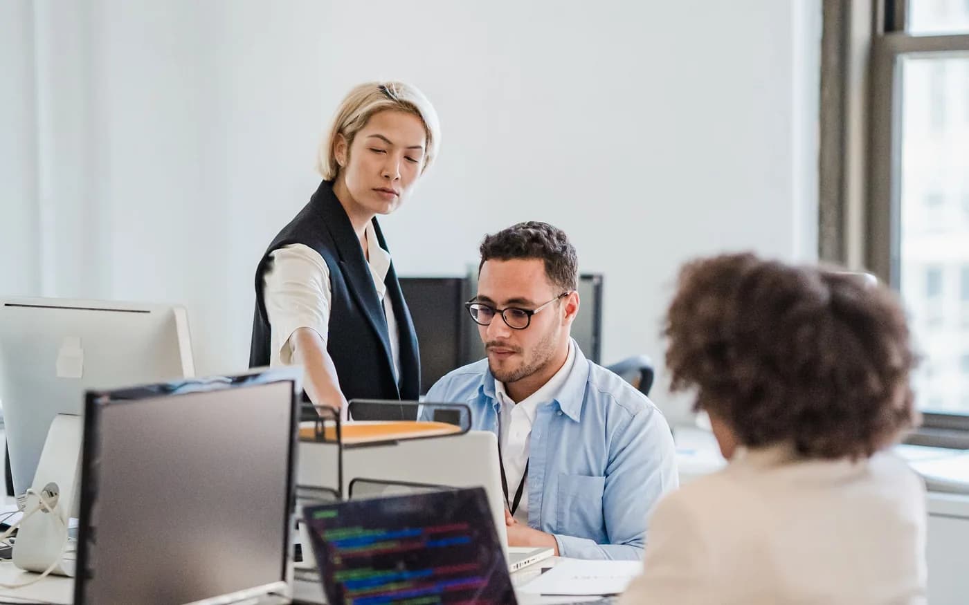 Professionals working on computers in a shared office