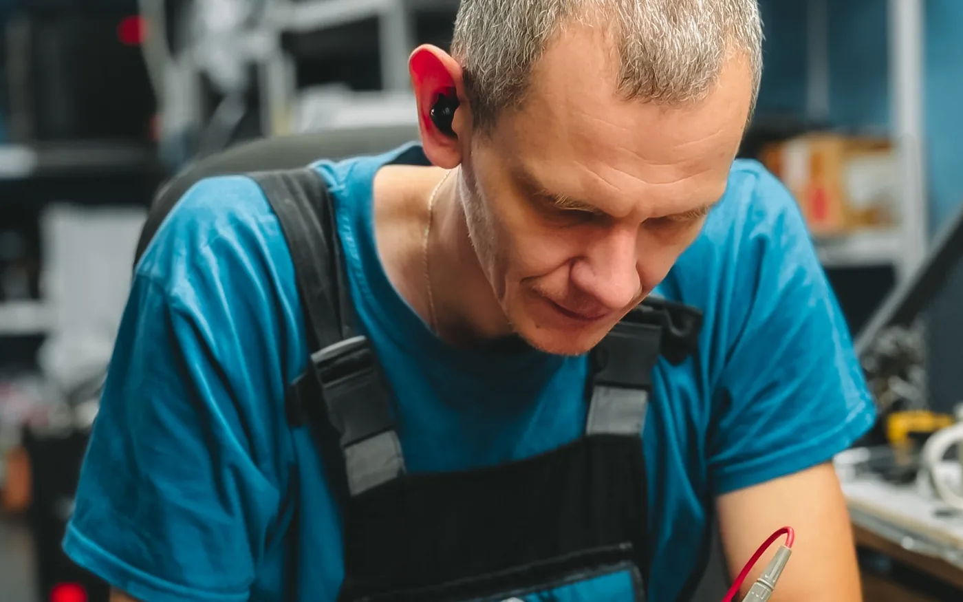 Technician repairing a laptop on a workbench