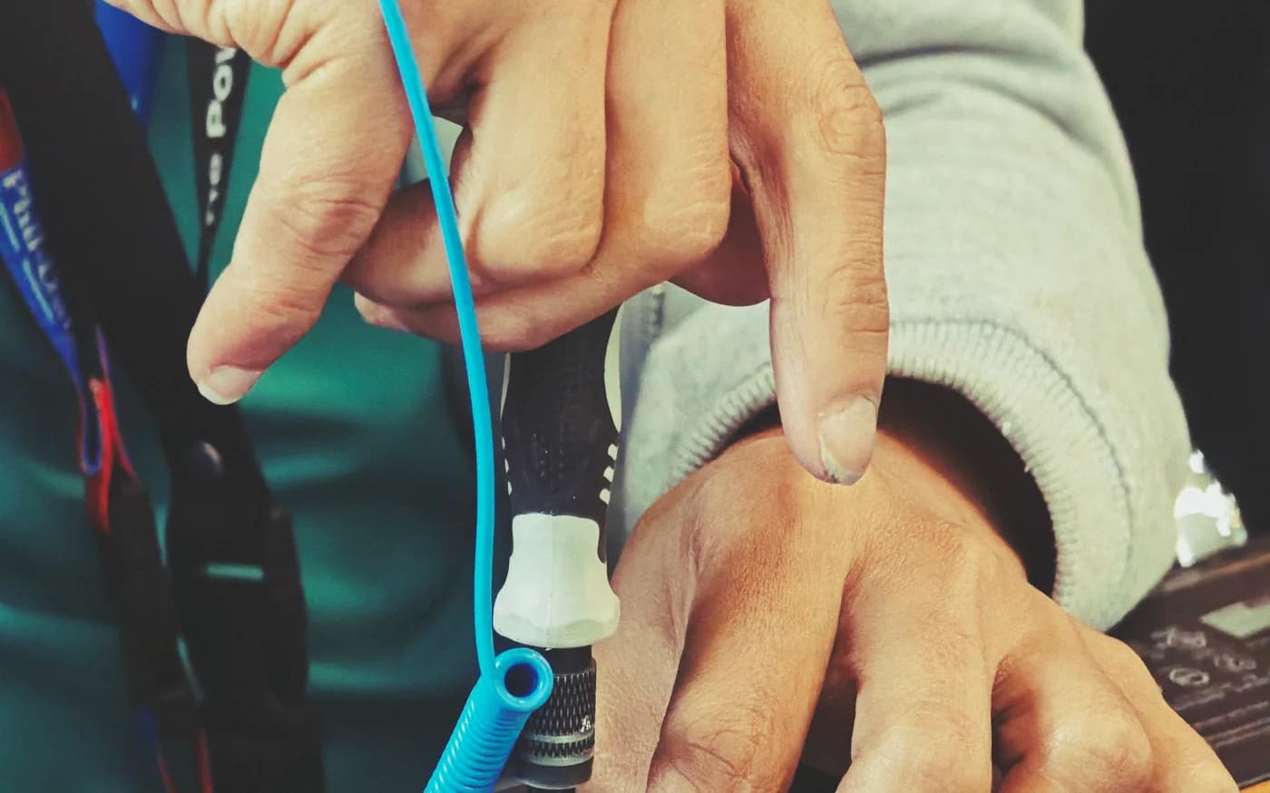 Hands inspecting exposed laptop components with a screwdriver